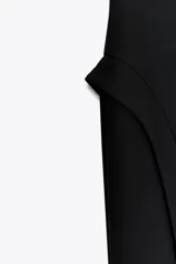 Vestido midi negro con escote corazón y hombros descubiertos. Cierre trasero con cremallera oculta.