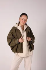 Campera bomber verde militar de corte holgado, con cierre frontal y cuello alto.