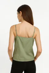 Musculosa blanca de algodón con breteles finos y escote cuadrado con detalle de puntilla.