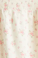 Vestido largo de algodón color crudo con estampado de pequeñas flores rosas, escote cuadrado, mangas cortas abullonadas con elástico y cuerpo fruncido.