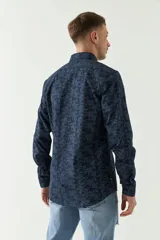 Camisa de manga larga con estampado de hojas en tonos azul marino y negro.