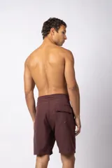 Short de baño color bordó, de corte recto y largo medio, con cordón de ajuste blanco en la cintura y pequeño parche con logo en la pierna derecha.