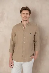 Camisa celeste de lino con cuello mao, corte slim fit, manga larga con puños abotonados y cierre frontal con botones.