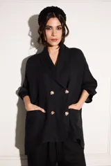Blazer holgado negro con solapas y cuatro botones dorados, confeccionado en lino 100%.