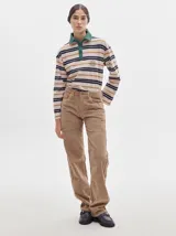 Remera polo de manga larga con rayas horizontales en blanco, rojo y verde. Cuello camisero rojo con cierre de dos botones y logo bordado en el pecho.