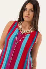 Vestido largo tejido a crochet con rayas verticales en colores fucsia, rojo y celeste.