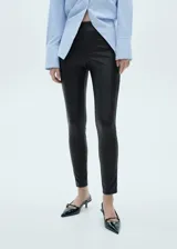 Pantalón negro de efecto piel, corte slim fit, cintura elástica y diseño largo.