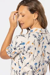 Camisa de manga corta con cuello camisero y estampado floral.
