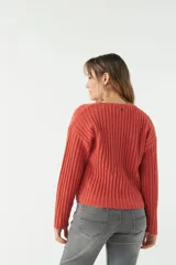 Sweater color beige de tejido de punto acanalado, con escote en V y corte ligeramente holgado.