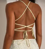 Top blanco con breteles finos y escote en V, con bordado de flores en relieve.