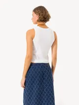 Musculosa blanca de algodón con cuello redondo y sisas amplias.
