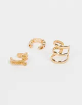 Set de tres cuffs dorados con diferentes diseños: uno con textura de pequeñas esferas, otro con diseño de eslabones y otro con triple aro.