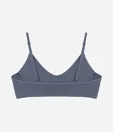 Soutien top gris de poliamida texturizada, sin costuras, con breteles finos ajustables, copas removibles y etiqueta Lov.