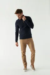 Buzo de felpa azul marino para hombre con medio cierre frontal, logo estampado en el pecho y puños. El modelo mide 1,80 m y usa talle M.