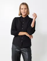 Camisa de viscosa con cuello con solapa y abertura central con botones, de manga ¾ con puño fruncido.