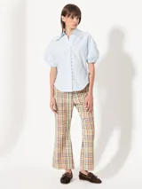 Camisa negra de popelina, de silueta amplia y diseño liviano. Incluye cuello clásico y cierre frontal con botones.