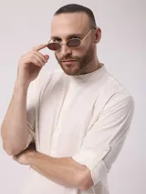 Camisa de lino color crudo, de manga larga con puños abotonados y cuello mao.