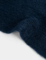Bufanda tejida de color azul marino con terminación de flecos.