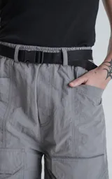 Bermuda gris con cinturón negro, bolsillos laterales y corte a la rodilla.