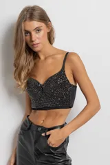 Top bustier negro con apliques de piedras negras brillantes, espalda elastizada y tirantes regulables.