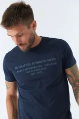 Remera blanca de algodón con cuello redondo y estampado frontal con texto en gris.