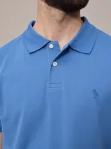 Remera polo color beige, de piqué de algodón, con cuello clásico y tapeta de dos botones.