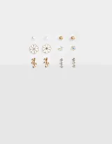 Set de seis pares de aros pasantes dorados con diferentes diseños: perlas, flores esmaltadas, esferas, cristales y hojas.