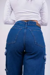 Pantalón de jean azul con parches en forma de estrella de un tono más claro y bordes desflecados.