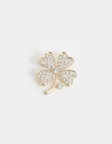 Broche dorado con forma de trébol de cuatro hojas, adornado con strass blancos.