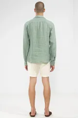 Camisa verde de lino con botones de madera, corte recto y mangas largas.