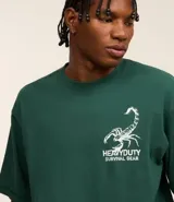 Remera verde oscuro de algodón, corte boxy, con cuello redondo y mangas cortas. Estampa frontal y trasera con lettering y dibujo de un escorpión.