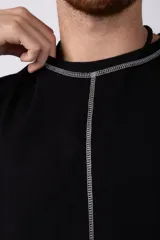 Musculosa color crudo de algodón estilo sudadera, corte oversize, con costuras verticales visibles en el frente y ruedo.