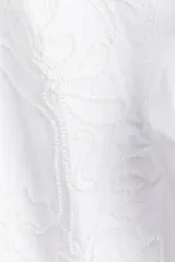 Camisa blanca de algodón con cuello mao, bordado floral tono sobre tono y cierre de botones. Tiene corte holgado, hombros caídos, mangas largas con abertura en los puños y bajo recto.