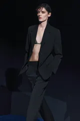 Pantalón negro de tiro medio, con trabillas en la cintura, bolsillos laterales y de vivo en la espalda, raya planchada en el delantero y pierna recta.