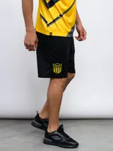 Short deportivo negro de poliéster con el escudo del Club Atlético Peñarol bordado en amarillo en la pierna derecha.