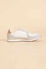 Zapatillas deportivas blancas con detalles en gris y marrón.