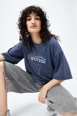 Remerón de manga corta color marrón con efecto lavado y estampa frontal de un caballo con texto estilo western.