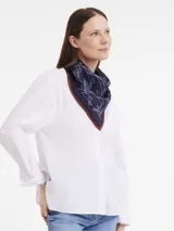 Pañuelo de seda azul marino con estampado de conejos en blanco y borde marrón.