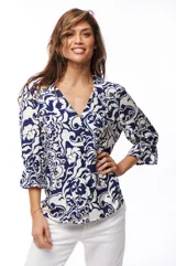Blusa estampada azul y blanca con escote en V, mangas 3/4 con volados y cierre frontal con botones.