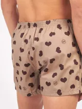 Bóxer de algodón blanco con estampado de flores pequeñas color celeste, con cintura elástica y logo de la marca en el centro.