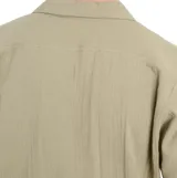 Camisa manga corta color verde con textura arrugada, cuello solapa, cierre con botones y bolsillo de parche en el pecho.