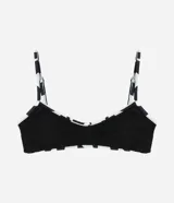 Top de bikini negro con textura acanalada, breteles finos y estampado geométrico en el contorno.