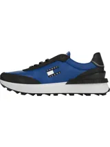 Zapatillas Tommy Jeans Essential de running, color azul con detalles en negro y blanco. Presentan el logo de la marca en el lateral y suela dentada.