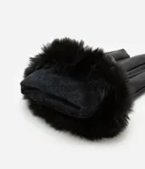 Par de guantes negros confeccionados en poliuretano, con detalle de piel sintética en los puños.