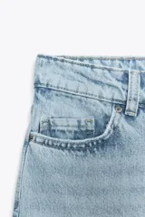 Pantalón de jean celeste de corte recto y largo, con tiro medio y cinco bolsillos.