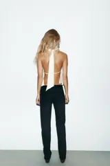 Pantalón de jean celeste de corte recto y tiro bajo, con cinco bolsillos y cierre frontal con cremallera y botón metálico.