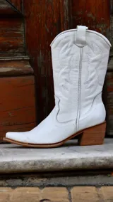 Bota texana de cuero color marrón, con caña media, punta fina y taco de madera.