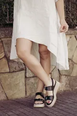 Sandalias negras de cuero con plataforma beige y doble tira con hebilla.