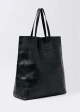 Bolso shopper grande de cuero negro con diseño patchwork y doble asa de hombro.