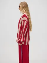 Cardigan a rayas verticales en colores pastel, con botones metalizados y logo bordado.